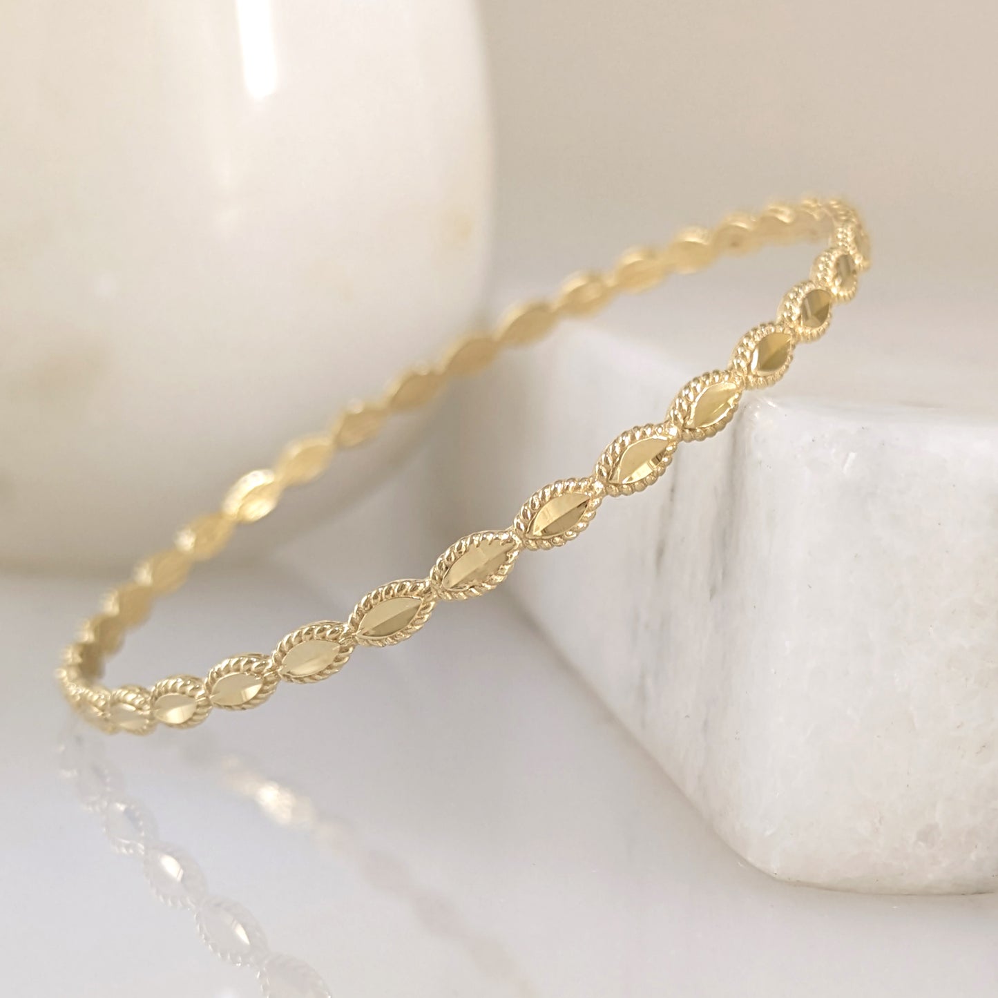 Textured Oval Link Bangle Bracelet with Sparkling Diamond Cut