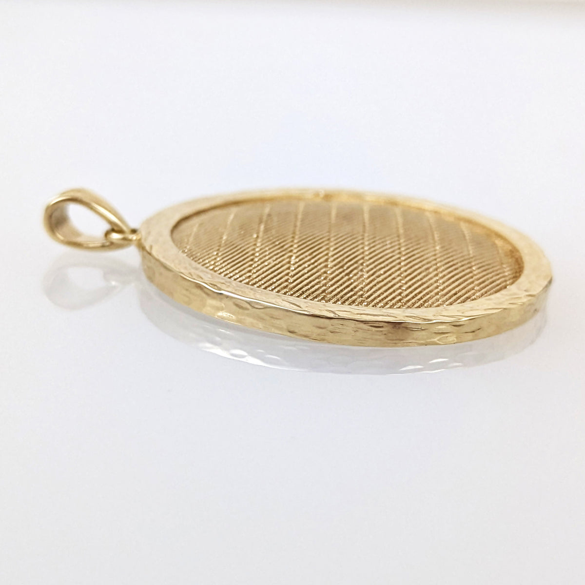 Gold pendant on a white background