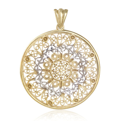 A round filigree pendant in yellow gold with a silver-toned center medallion, shown on a clean white background with a subtle reflection below.