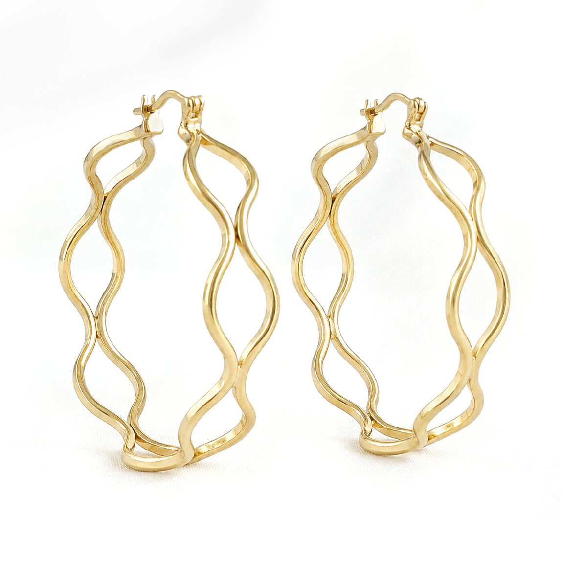 A pair of gold hoop earrings with a wavy, open-frame design, displayed on a clean white background.