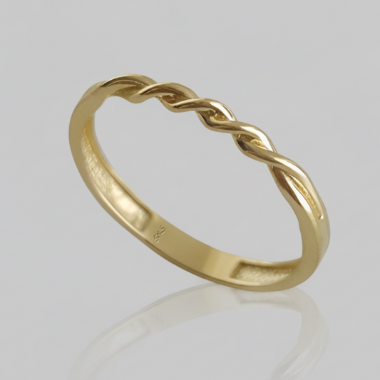 A polished yellow gold ring with a twisted, braided design on the upper half, shown against a solid gray background.