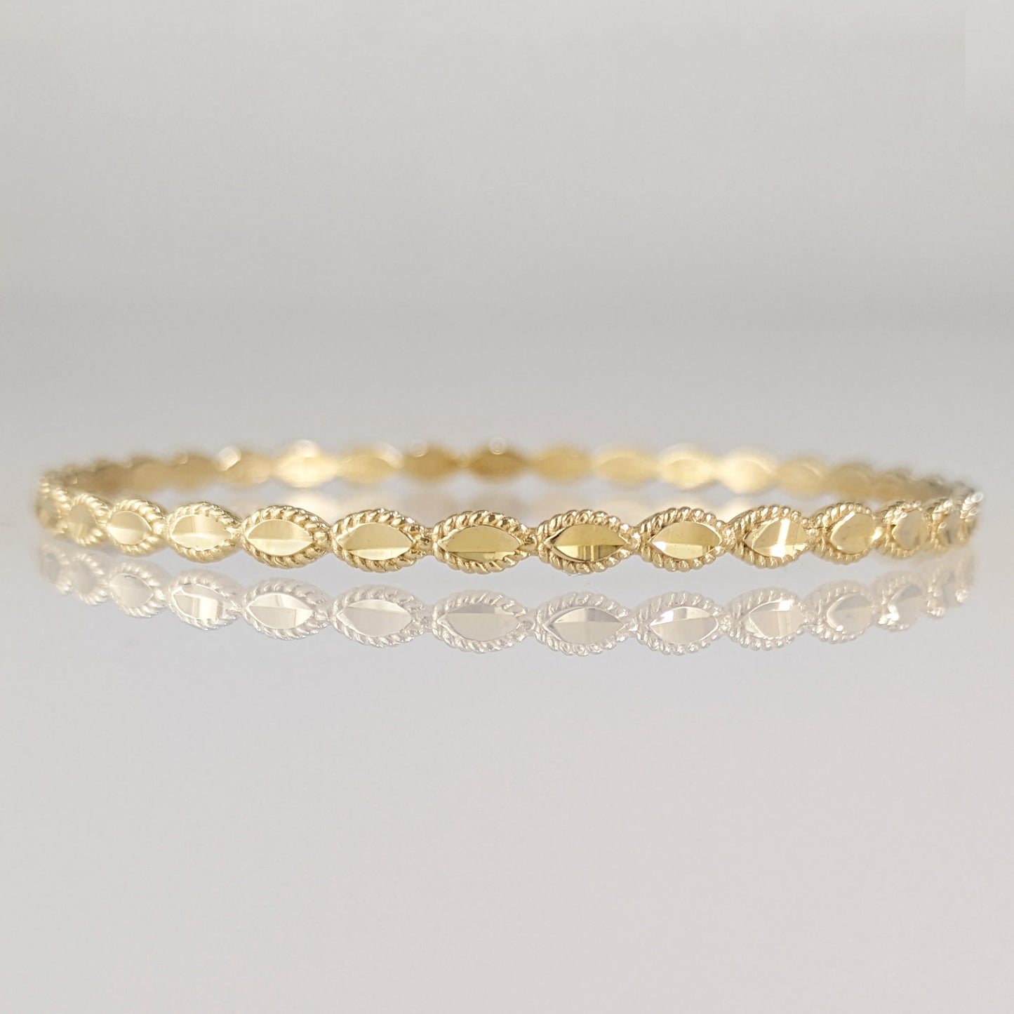 Textured Oval Link Bangle Bracelet with Sparkling Diamond Cut