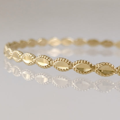 Textured Oval Link Bangle Bracelet with Sparkling Diamond Cut