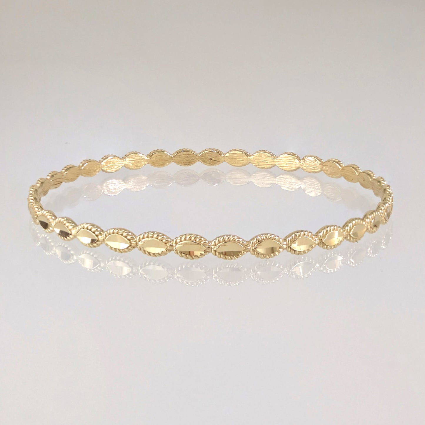 Textured Oval Link Bangle Bracelet with Sparkling Diamond Cut