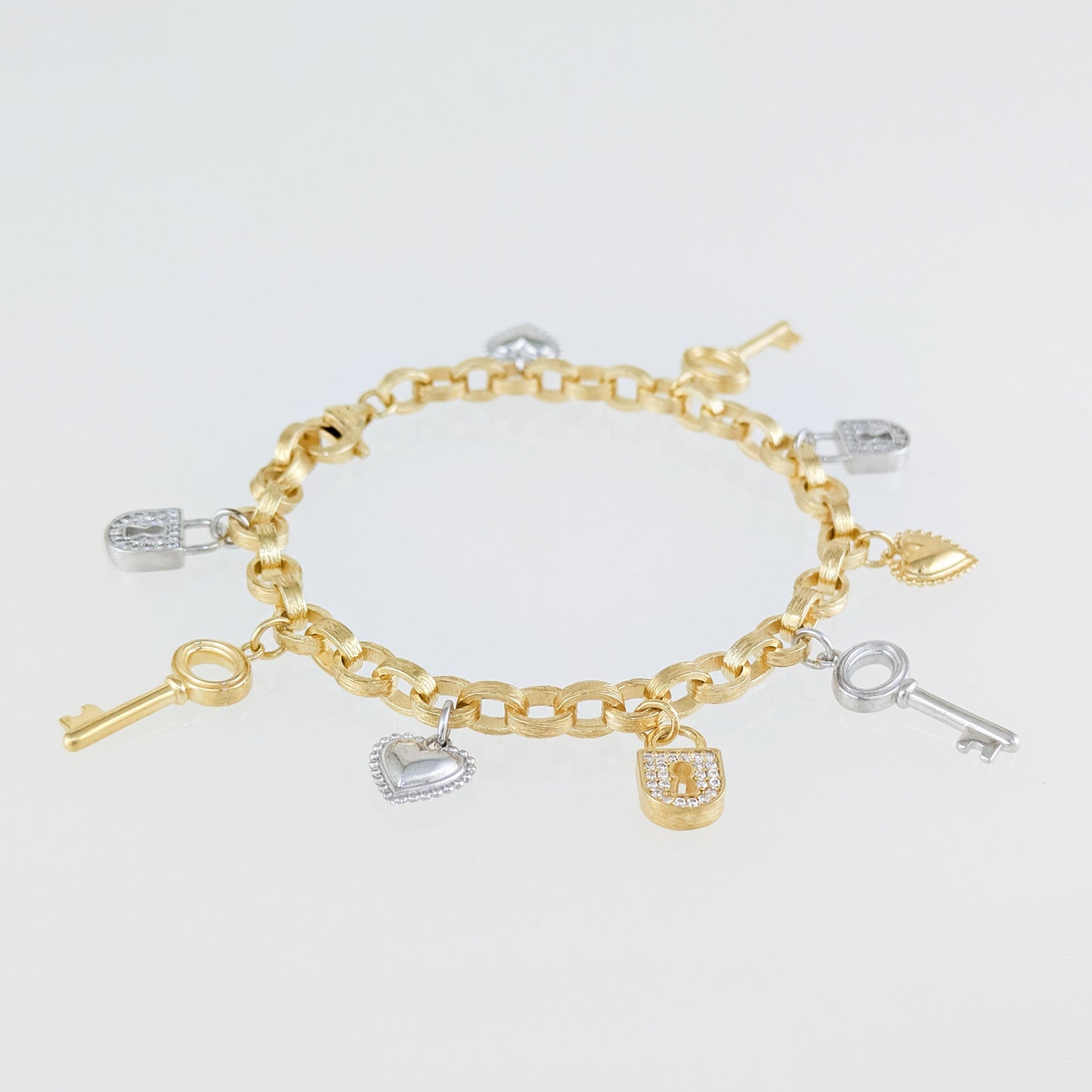 Two-Tone Lock & Key Charm Bracelet with Heart Accents