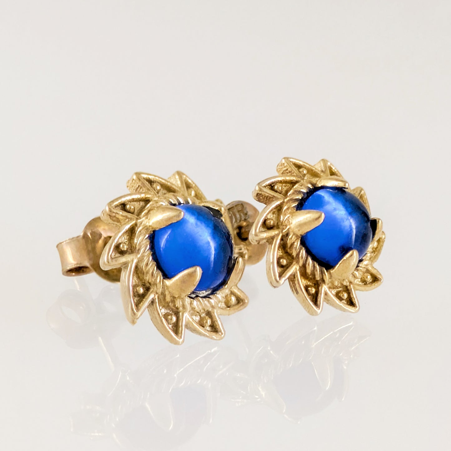 Blue Crystal Cabochon Stud Earrings with Ornate Sunburst Design