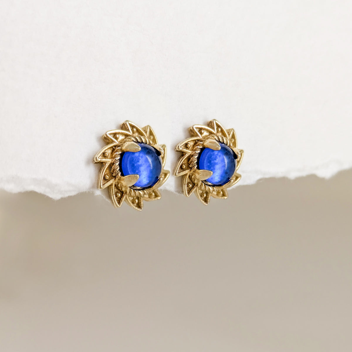 Blue Crystal Cabochon Stud Earrings with Ornate Sunburst Design