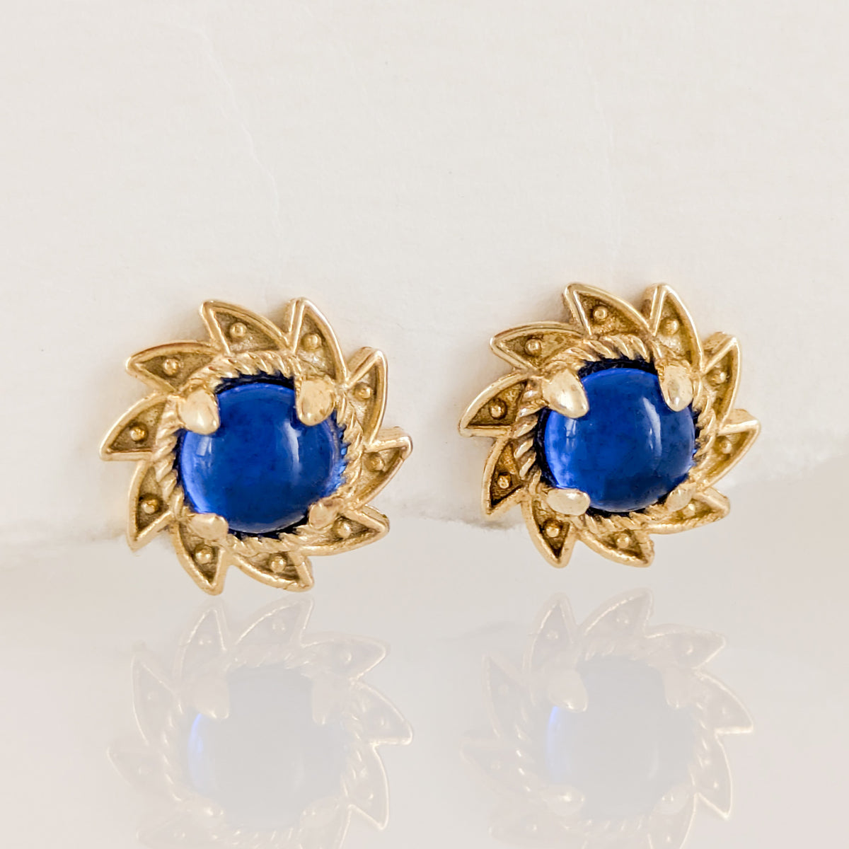 Blue Crystal Cabochon Stud Earrings with Ornate Sunburst Design