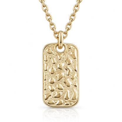 A gold rectangular dog tag pendant necklace with a textured, pebble-like raised pattern, hanging from a gold link chain on a white background.