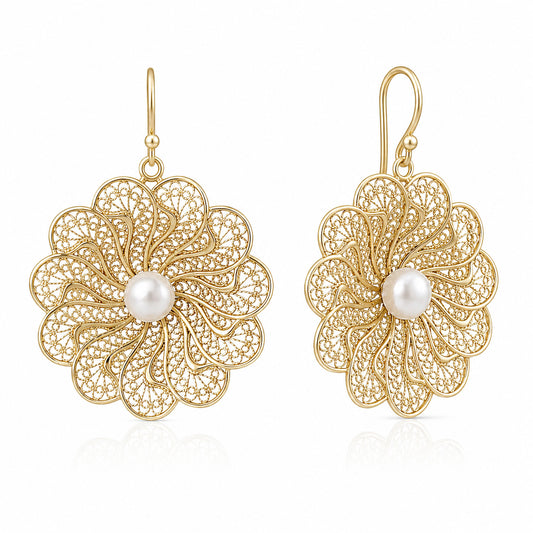 A pair of gold filigree flower drop earrings with a central white pearl, shown on a clean white background.