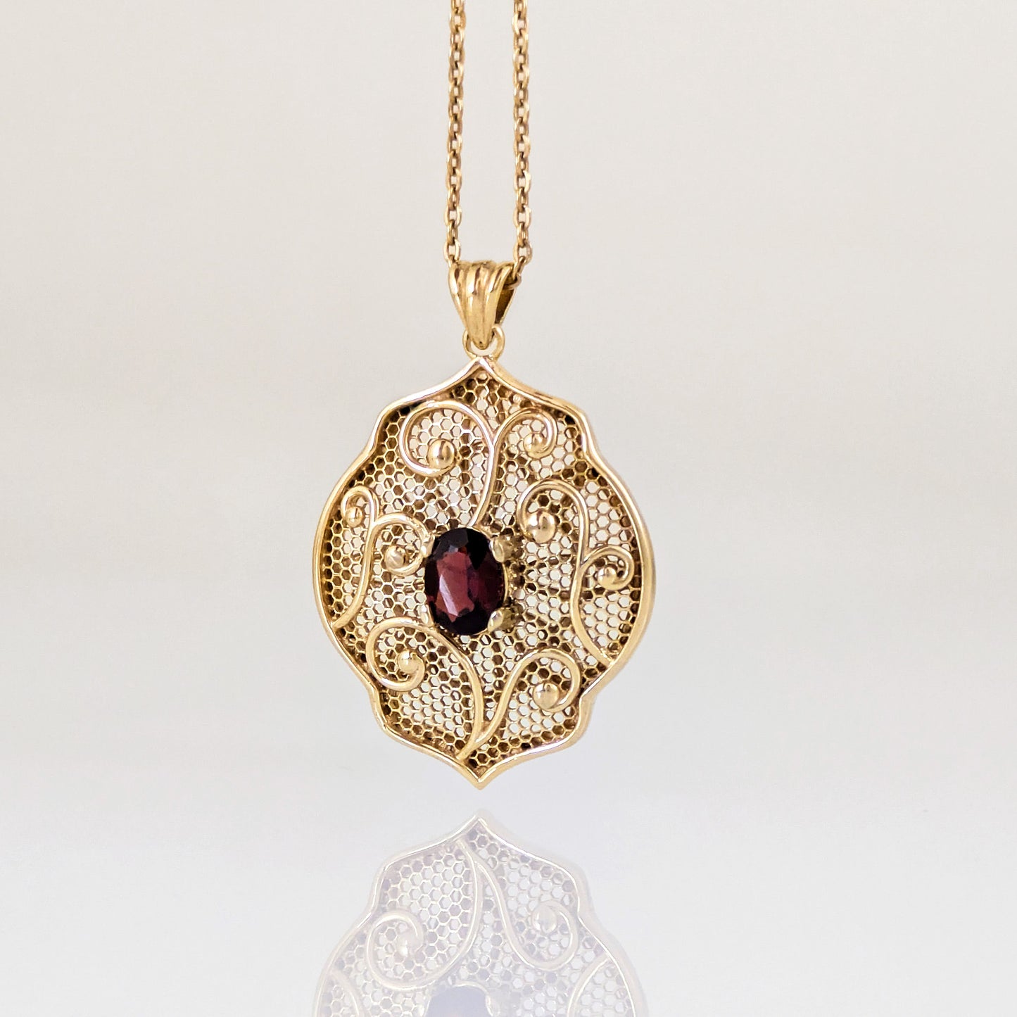 Natural Garnet Filigree Pendant with Ornate Scrollwork Design