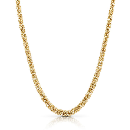 A gold graduated byzantine chain necklace with a textured, woven link design, shown in a clean studio shot against a white background with a subtle reflection.