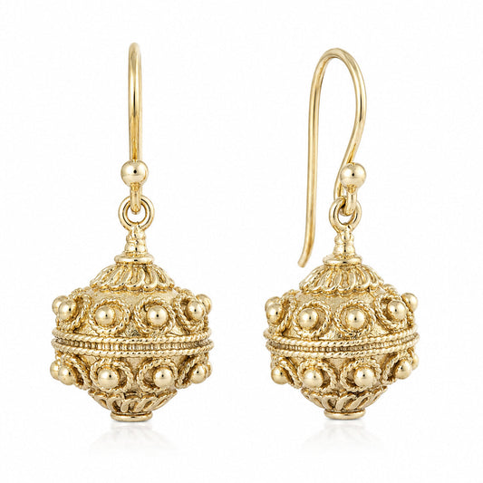 A pair of gold filigree dangle earrings with spherical beadwork and hook backs, shown on a clean white background.